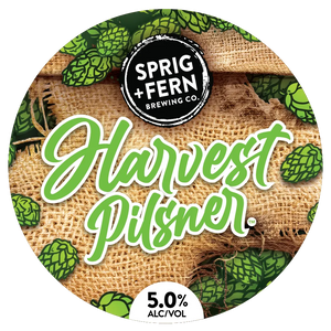 Round label for Sprig + Fern Brewing Co. Harvest Pilsner with burlap and hop cones.