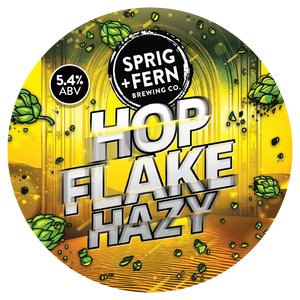 Round label for Sprig + Fern Brewing Co. Hop Flake Hazy beer with hop leaves and ABV information.