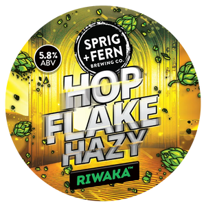 Round label for Sprig + Fern Brewing Co. Hop Flake Hazy beer with Riwaka hop cones and branding elements.
