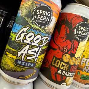 Two cans of Sprig + Fern Brewing Co. beer, one labeled 'Good As!' and the other 'Lock, Box & Barrel', on a dark background.