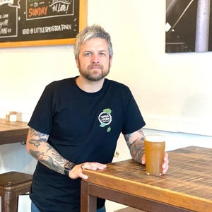 The owner of Little Sprig Seatoun, Tom Watson with a pint of Sprig + Fern beer.