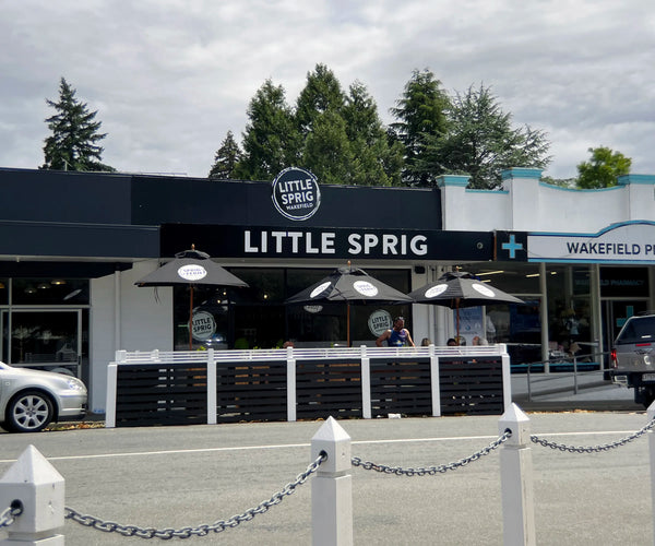 Front of Little Sprig Wakefield Tavern with outdoor seating area on a cloudy day.