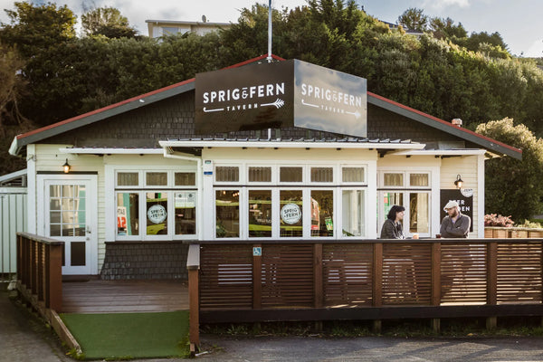 Sprig + Fern Tawa Tavern with people sitting outside on a sunny day