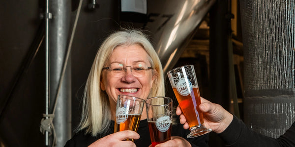 Tracy Banner Master Brewer and owner of Sprig + Fern Brewing Co. holding a glass of Sprig + Fern beer