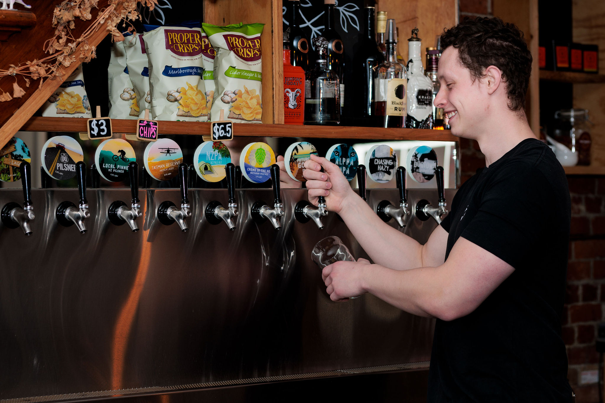 A man pouring a beer at Sprig and Fern Petone