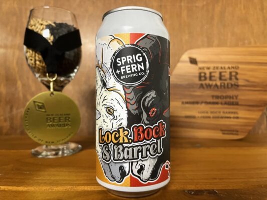 A can of Lock Bock and Barrel with a gold medal and trophy from the Brewers Guild of NZ Beer Awards