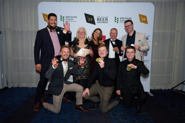 Jeff Lepa, Tracy Banner, Lois Lester, Ken Banner, Callum Duncan, Daniel Tipping, Joe and Cameron Banner from Sprig and Fern with a collection of Brewers Guild of NZ Beer Awards medals