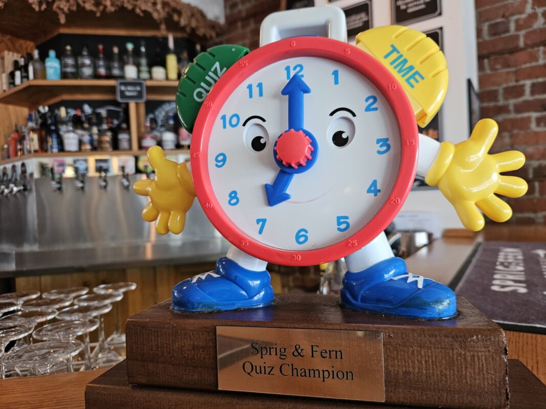 The quiz night trophy of Sprig and Fern Petone, a toy clock with Quiz Time written on it